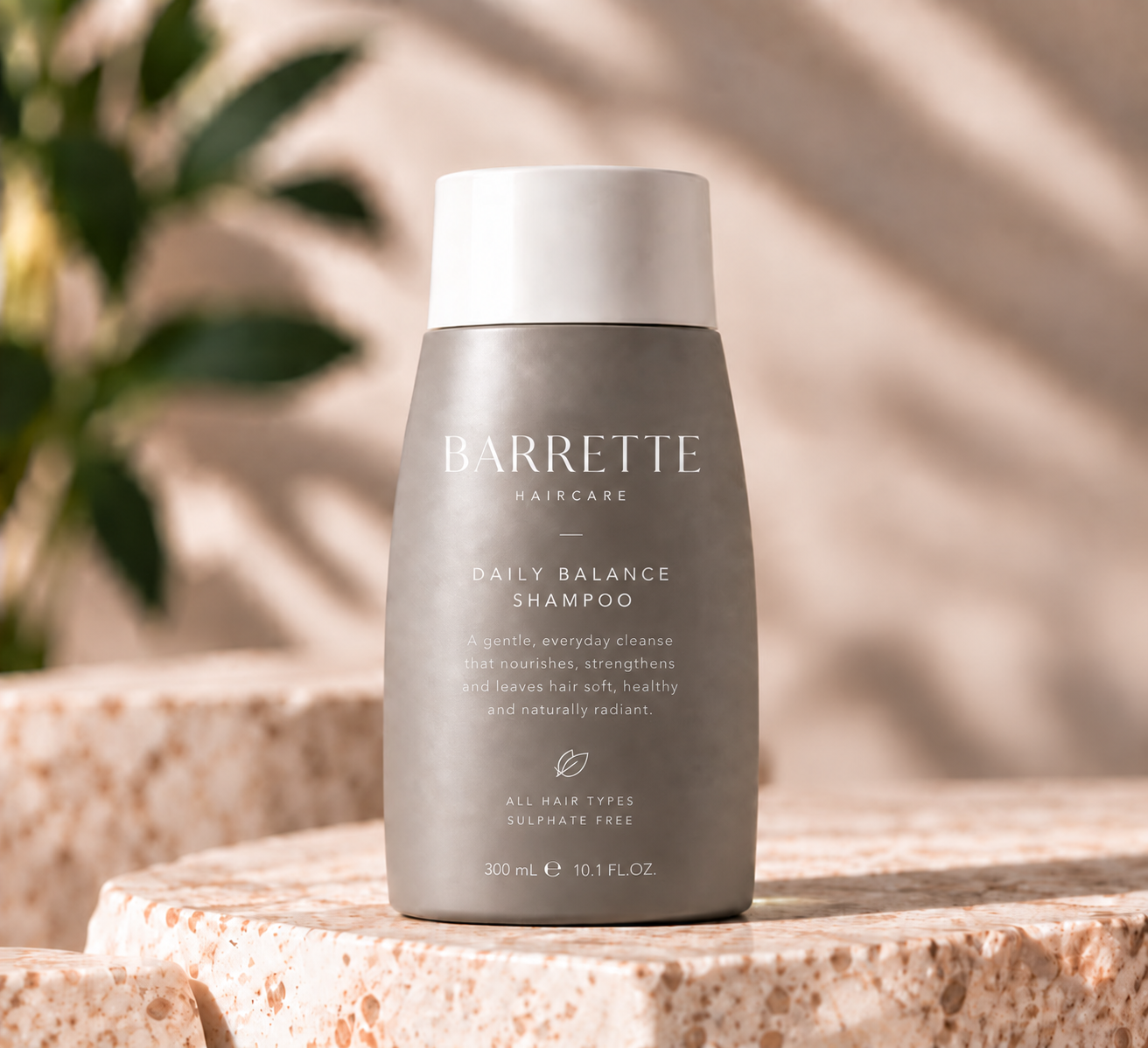 Barrette Haircare Daily Balance Shampoo bottle on a stone plinth